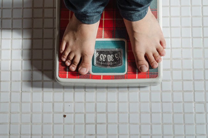 Person using a weighing scale