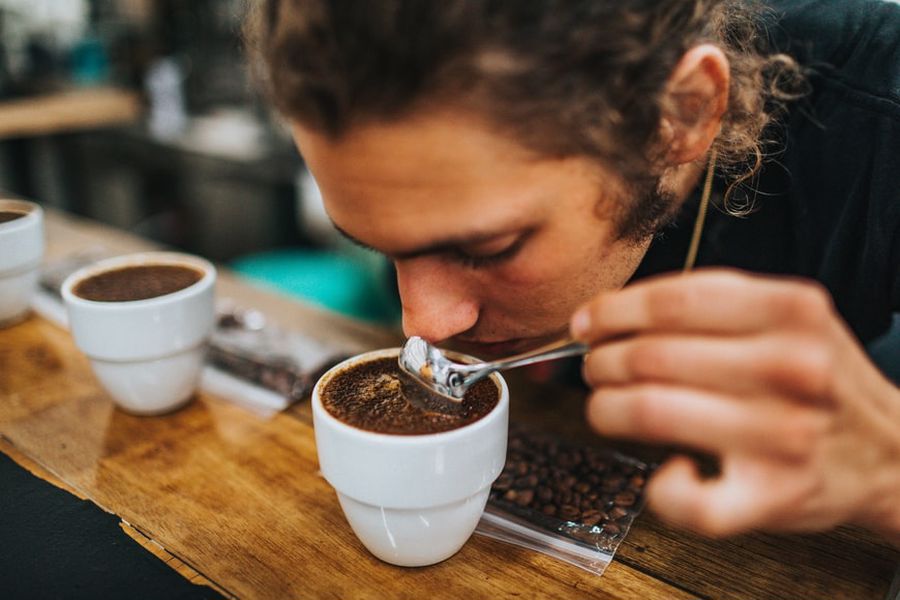 Man taking a sip of a CBD infused coffee